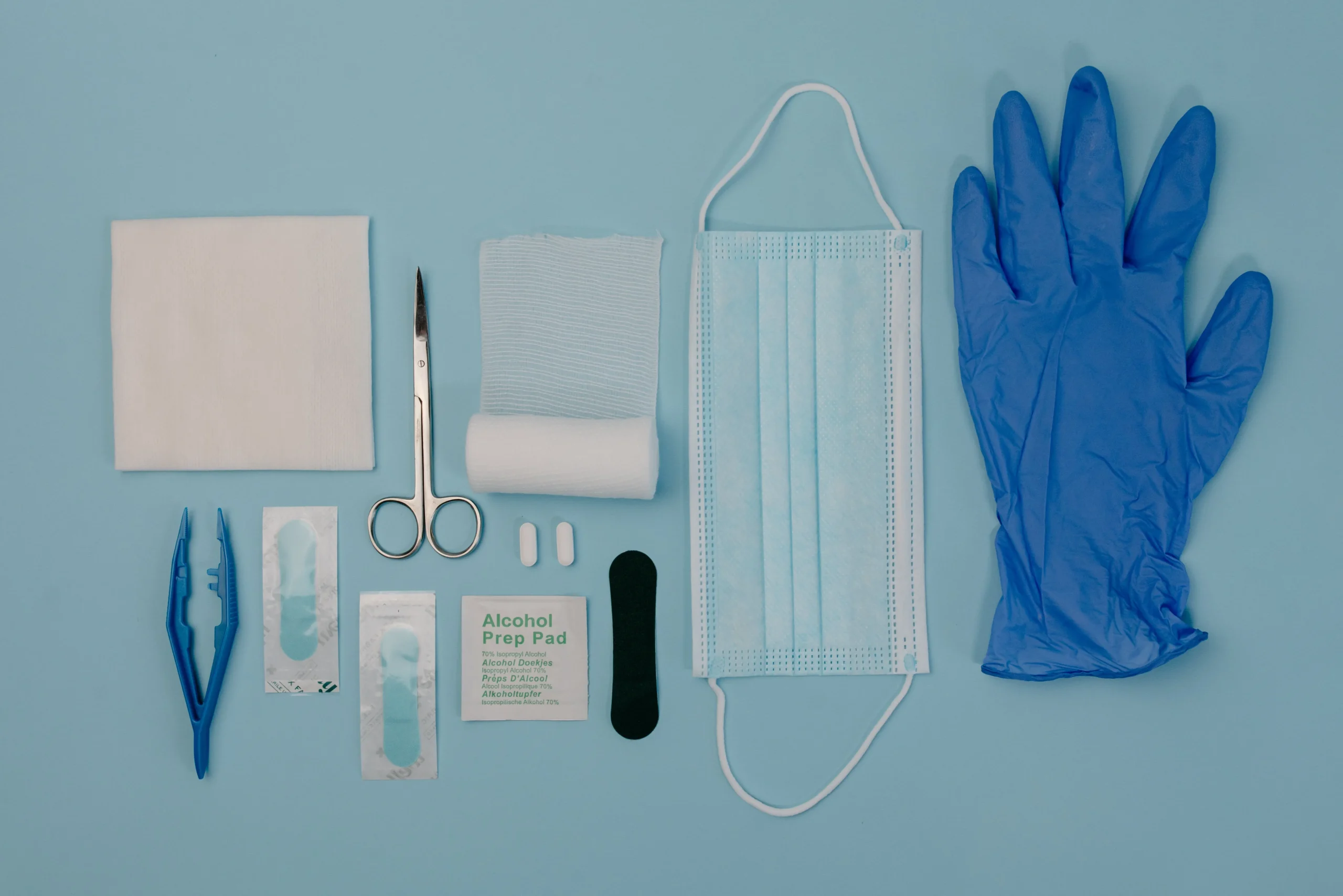 Picture of basics that should be in first aid kit such as gloves, scissors, alcohol prep wipes etc.