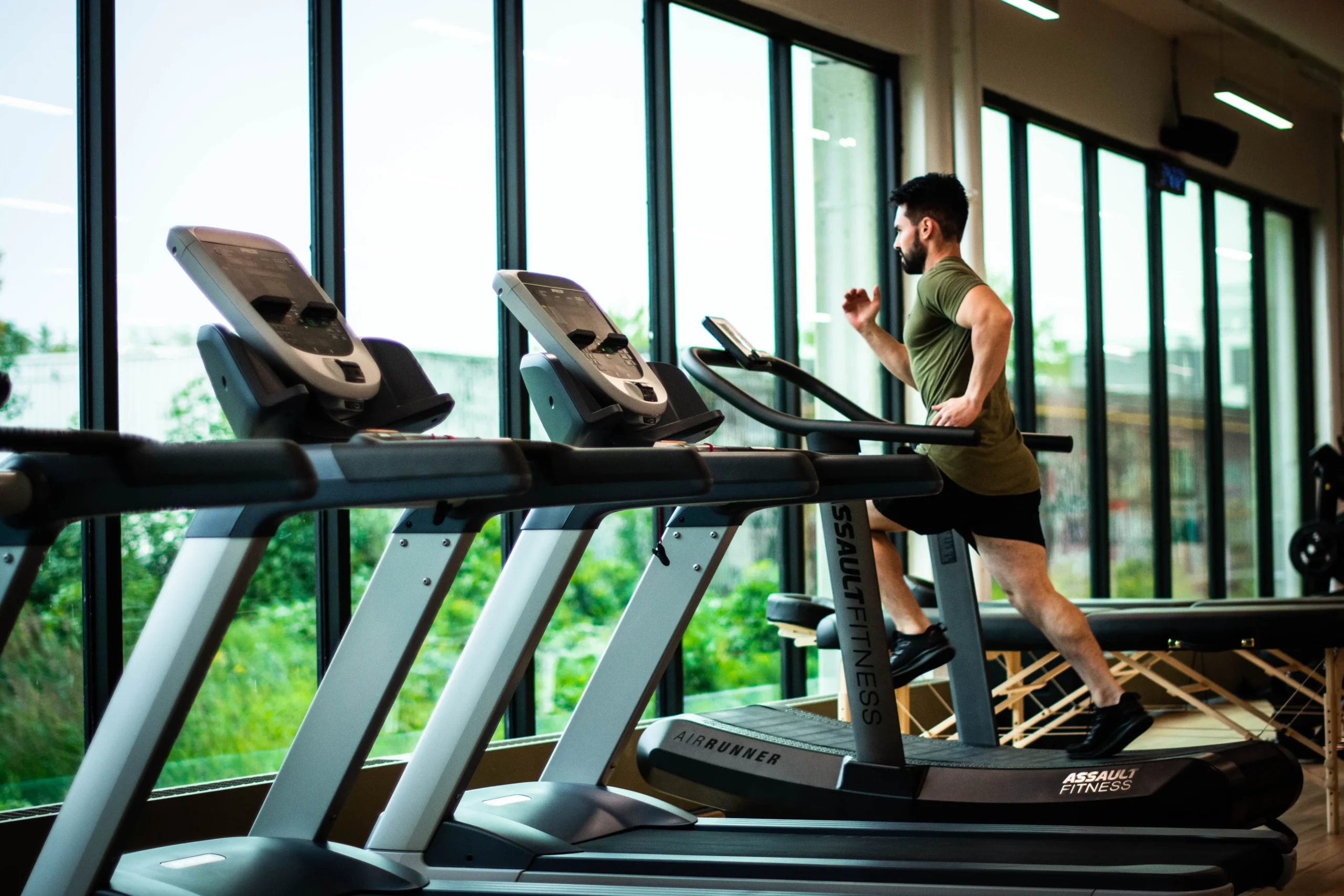 Man jogging on a treadmill in a gym