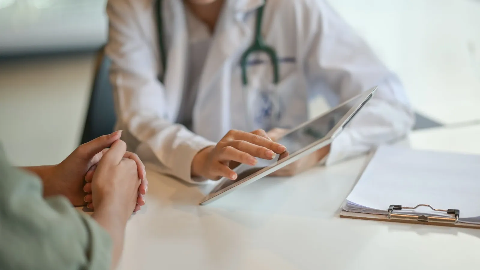 Picture of doctor showing patient information on an ipad